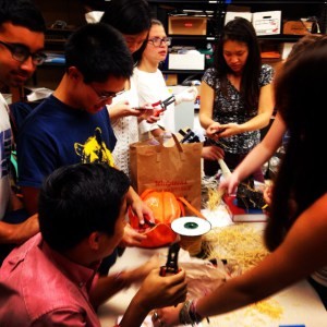 BEAM mentors stripping wires so that their kids can build LED-lit ornaments for Dr Ella Mental’s Lab.