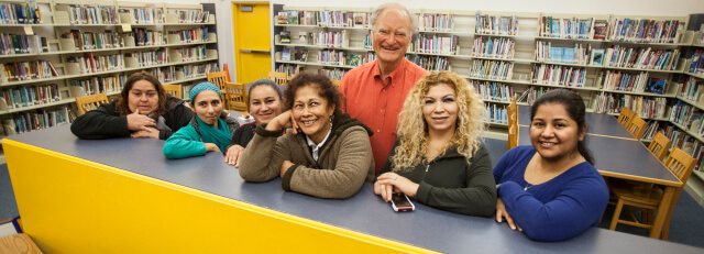 PVF’s Bill Somerville (center) and parents at Cesar Chavez Academy in East Palo Alto. These parents are encouraged by Parent Involvement Workers to be active at their children’s school.